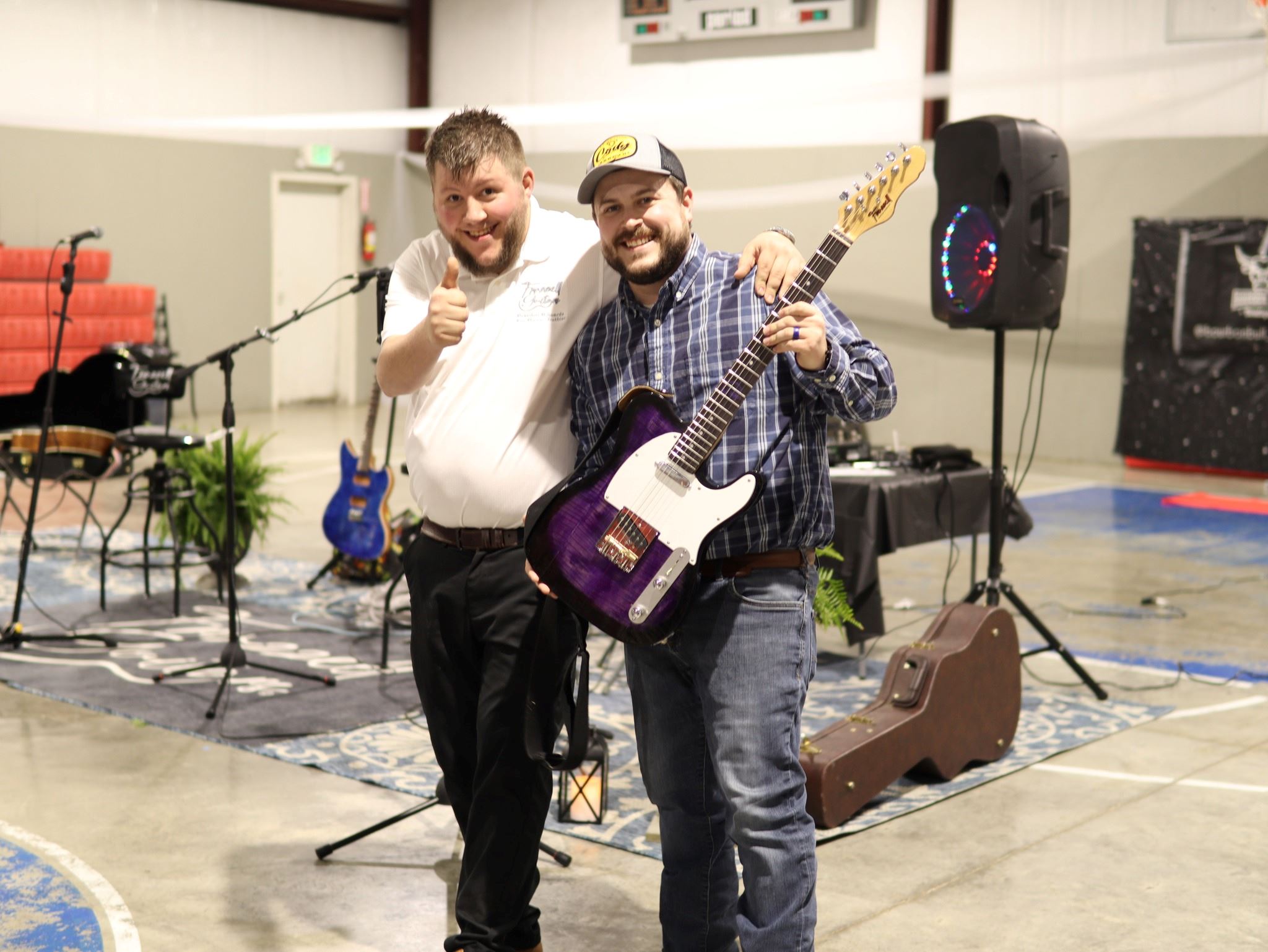 Brandon Edwards and Country Artist, Jeff Stauffer, displays custom guitar
