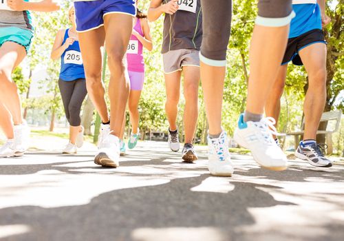 men and women running in 5k on blacktop